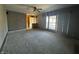 Spacious living room featuring carpet, a large window, and a ceiling fan at 2115 Leonard Rd, Martinsville, IN 46151