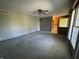 Large living room featuring carpet, a ceiling fan, and a view of the front entryway at 2115 Leonard Rd, Martinsville, IN 46151
