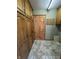Pantry area features wood cabinets, tile floors, and door at 2115 Leonard Rd, Martinsville, IN 46151