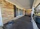 Inviting covered porch with brick detail, offering a cozy outdoor space and view of surrounding greenery at 2115 Leonard Rd, Martinsville, IN 46151
