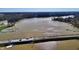Expansive aerial view of waterfront property, featuring boat docks and a bridge with light traffic at 307 Baywood Ct # 67, Noblesville, IN 46062