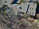 Birds eye view of townhouse complex, with multiple rooftops, some decks, and mature trees at 307 Baywood Ct # 67, Noblesville, IN 46062