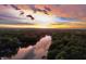 Picturesque aerial view of a river surrounded by lush trees and a vibrant sunset sky at 307 Baywood Ct # 67, Noblesville, IN 46062