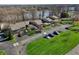 Aerial view of townhouses featuring attached garages, lush lawns, and convenient parking at 307 Baywood Ct # 67, Noblesville, IN 46062