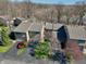 Aerial view of townhouses with attached garages, mature trees, and well-kept landscaping at 307 Baywood Ct # 67, Noblesville, IN 46062