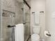 Bathroom with a sleek, glass-enclosed shower, a toilet, and tile walls at 307 Baywood Ct # 67, Noblesville, IN 46062