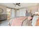 Bedroom with ceiling fan, sliding barn door to bathroom, and dresser at 307 Baywood Ct # 67, Noblesville, IN 46062