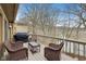 Outdoor deck with wicker furniture and a barbecue grill, ideal for relaxation and outdoor cooking with nature views at 307 Baywood Ct # 67, Noblesville, IN 46062