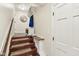 Inviting entryway with wood stairs, a stylish mirror, and convenient storage cubbies and bench seating at 307 Baywood Ct # 67, Noblesville, IN 46062