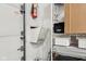 Garage wall storage featuring shelves, racks, and a fire extinguisher for safety and organization at 307 Baywood Ct # 67, Noblesville, IN 46062