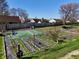 Extensive backyard garden space with raised beds and partially covered area, showcasing gardening potential at 307 Baywood Ct # 67, Noblesville, IN 46062