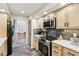 Modern kitchen with stainless steel appliances, light wood cabinets, and stone backsplash, offering a stylish cooking space at 307 Baywood Ct # 67, Noblesville, IN 46062