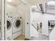 Functional laundry room with modern washer and dryer units, storage cabinets, and access to the home's staircase at 307 Baywood Ct # 67, Noblesville, IN 46062