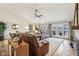 Spacious living area with hardwood floors, large windows, a fireplace, and comfortable leather seating at 307 Baywood Ct # 67, Noblesville, IN 46062