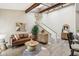 Bright living area featuring vaulted ceilings, wooden beams, modern decor, and stylish furnishings at 307 Baywood Ct # 67, Noblesville, IN 46062