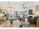 Bright living room with hardwood floors, stone fireplace, comfortable seating, and access to an outdoor balcony at 307 Baywood Ct # 67, Noblesville, IN 46062