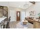 Cozy living room with a leather sofa, round coffee table, spiral staircase, and ample natural light at 307 Baywood Ct # 67, Noblesville, IN 46062