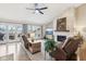 Inviting living room featuring a stone fireplace, hardwood floors, and access to an outdoor deck with scenic views at 307 Baywood Ct # 67, Noblesville, IN 46062