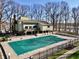 Aerial shot of a covered pool, showing the house exterior with balconies and a surrounding fence at 307 Baywood Ct # 67, Noblesville, IN 46062