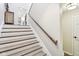 White and wood staircase with wooden railing and white walls at 307 Baywood Ct # 67, Noblesville, IN 46062