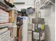 Functional utility room featuring a water heater, water softener system, and storage shelving at 307 Baywood Ct # 67, Noblesville, IN 46062
