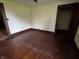 Bedroom with hardwood floors, natural woodwork, and closet access at 3179 W 400 N, Fairland, IN 46126