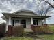 Cozy home with a covered porch and brick foundation, set amidst a picturesque landscape of trees and greenery at 3179 W 400 N, Fairland, IN 46126
