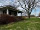 Quaint home featuring a brick porch, well-maintained lawn, and mature trees offering plenty of shade at 3179 W 400 N, Fairland, IN 46126