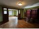 A living room with olive-green walls, natural woodwork, and hardwood floors at 3179 W 400 N, Fairland, IN 46126