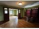 A living room with olive-green walls, natural woodwork, and hardwood floors at 3179 W 400 N, Fairland, IN 46126