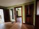 A living room with olive-green walls, natural woodwork and hardwood floors at 3179 W 400 N, Fairland, IN 46126