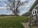Expansive green yard with a few trees, offering plenty of space next to the house at 3179 W 400 N, Fairland, IN 46126