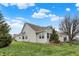 View of the rear of the home with a well-maintained yard, and mature landscaping at 3447 Heathcliff Ct, Westfield, IN 46074