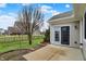 Patio walk out into the grassy backyard with a black metal fence at 3447 Heathcliff Ct, Westfield, IN 46074