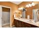 Bathroom featuring double sinks, wood cabinets, large mirror and walk in shower at 3447 Heathcliff Ct, Westfield, IN 46074