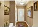 Inviting entryway showcasing hardwood floors, artwork, and a charming bench at 3447 Heathcliff Ct, Westfield, IN 46074