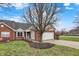 Charming brick home featuring a well-manicured lawn and a delightful blue door with attached two-car garage at 3447 Heathcliff Ct, Westfield, IN 46074