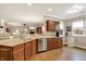 An open-concept kitchen featuring wooden cabinets, granite countertops, and stainless steel appliances at 3447 Heathcliff Ct, Westfield, IN 46074