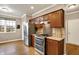 Modern kitchen featuring stainless steel appliances, wood cabinetry, and hardwood flooring at 3447 Heathcliff Ct, Westfield, IN 46074