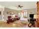 Comfortable living room featuring hardwood floors, neutral walls, ceiling fan, area rug and furnishings at 3447 Heathcliff Ct, Westfield, IN 46074