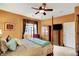 Comfortable main bedroom with a ceiling fan, mounted TV, and large window at 3447 Heathcliff Ct, Westfield, IN 46074
