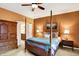 Cozy main bedroom with a four-poster bed, ceiling fan and ensuite bathroom access at 3447 Heathcliff Ct, Westfield, IN 46074