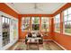 Bright sunroom with orange walls, tile floors, and plenty of natural light, a perfect spot to relax at 3447 Heathcliff Ct, Westfield, IN 46074