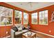 Charming sunroom featuring tile floors, orange walls, lots of windows and natural light and comfortable seating at 3447 Heathcliff Ct, Westfield, IN 46074