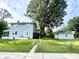 Home exterior and matching detached garage in backyard with green grass at 3601 Carrollton Ave, Indianapolis, IN 46205