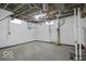 Unfinished basement area, exposed piping on the ceiling and concrete flooring at 3601 Carrollton Ave, Indianapolis, IN 46205