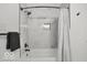 Modern bathroom featuring a tub with stylish shower curtain and contemporary fixtures at 3601 Carrollton Ave, Indianapolis, IN 46205