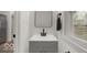 Modern bathroom with sleek gray vanity, black fixtures, and bright natural light at 3601 Carrollton Ave, Indianapolis, IN 46205