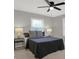 Comfortable bedroom with ceiling fan, neutral walls, and two large windows at 3601 Carrollton Ave, Indianapolis, IN 46205