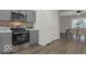 Charming kitchen with stainless steel appliances and open layout to dining room at 3601 Carrollton Ave, Indianapolis, IN 46205